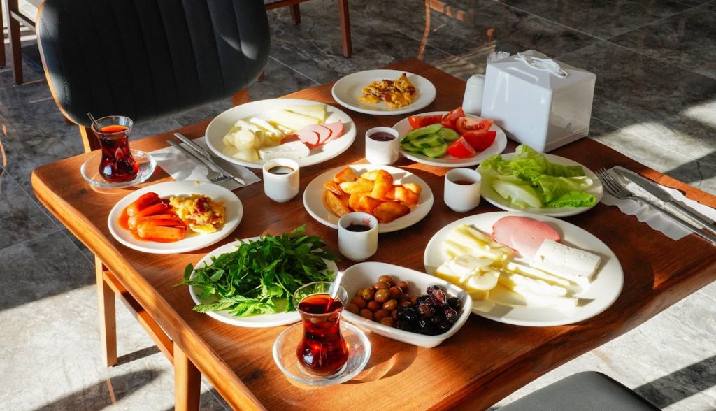 pexels-photo-33935503 A vibrant traditional Turkish breakfast spread with tea, cheese, and fresh vegetables in Niğde, Türkiye.